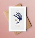 A beautiful set of 5 Thank You note cards, complete with kraft envelopes. Card designs feature blue and gold beach inspired illustrations, including seaweed and pebbles.