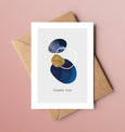 A beautiful set of 5 Thank You note cards, complete with kraft envelopes. Card designs feature blue and gold beach inspired illustrations, including seaweed and pebbles.