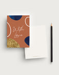 Postcard writing set with a terracotta coloured background and the words 'With Love' in a handwritten font