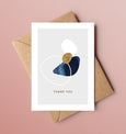 A beautiful set of 5 Thank You note cards, complete with kraft envelopes. Card designs feature blue and gold beach inspired illustrations, including seaweed and pebbles.