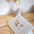 A beautiful set of 5 Thank You note cards, complete with kraft envelopes. Card designs feature blue and gold beach inspired illustrations, including seaweed and pebbles.