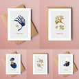 A beautiful set of 5 Thank You note cards, complete with kraft envelopes. Card designs feature blue and gold beach inspired illustrations, including seaweed and pebbles.